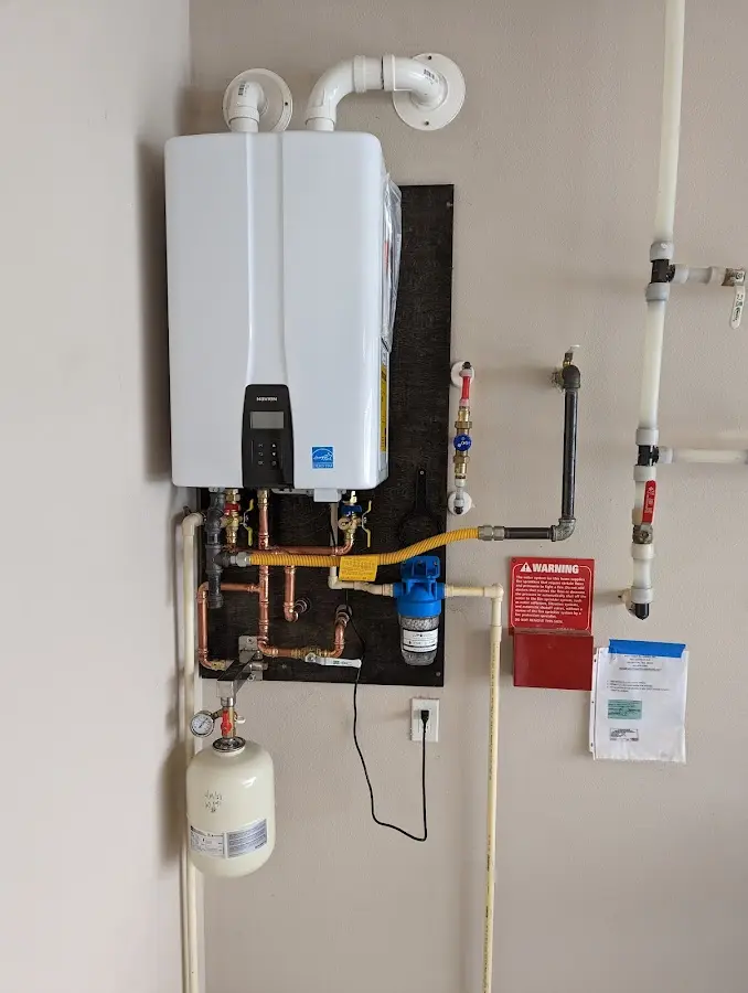 Professional plumber installing copper piping in a Kuna home